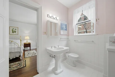 a bathroom with a toilet sink and mirror