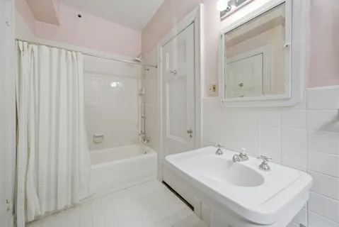 a white bath tub sitting next to a white sink
