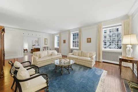 a living room with furniture wooden floor and a window