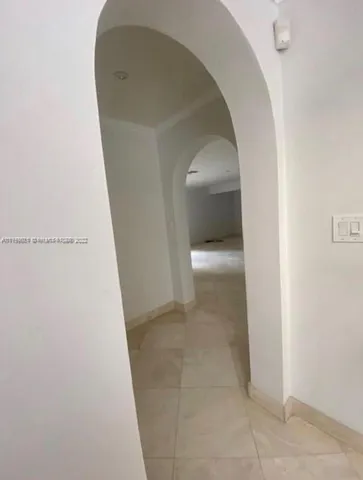 a view of a livingroom with an empty space and a fireplace