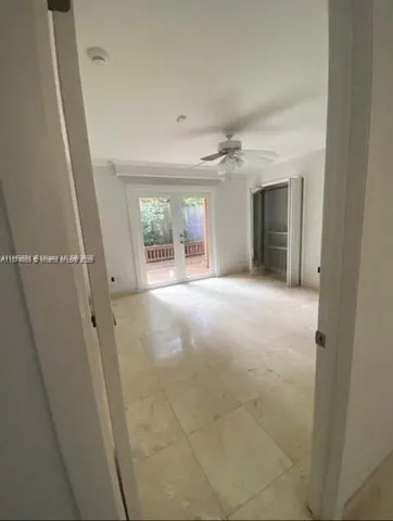 a view of a big room with wooden floor and windows