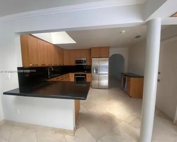 view of a big room with windows and chandelier