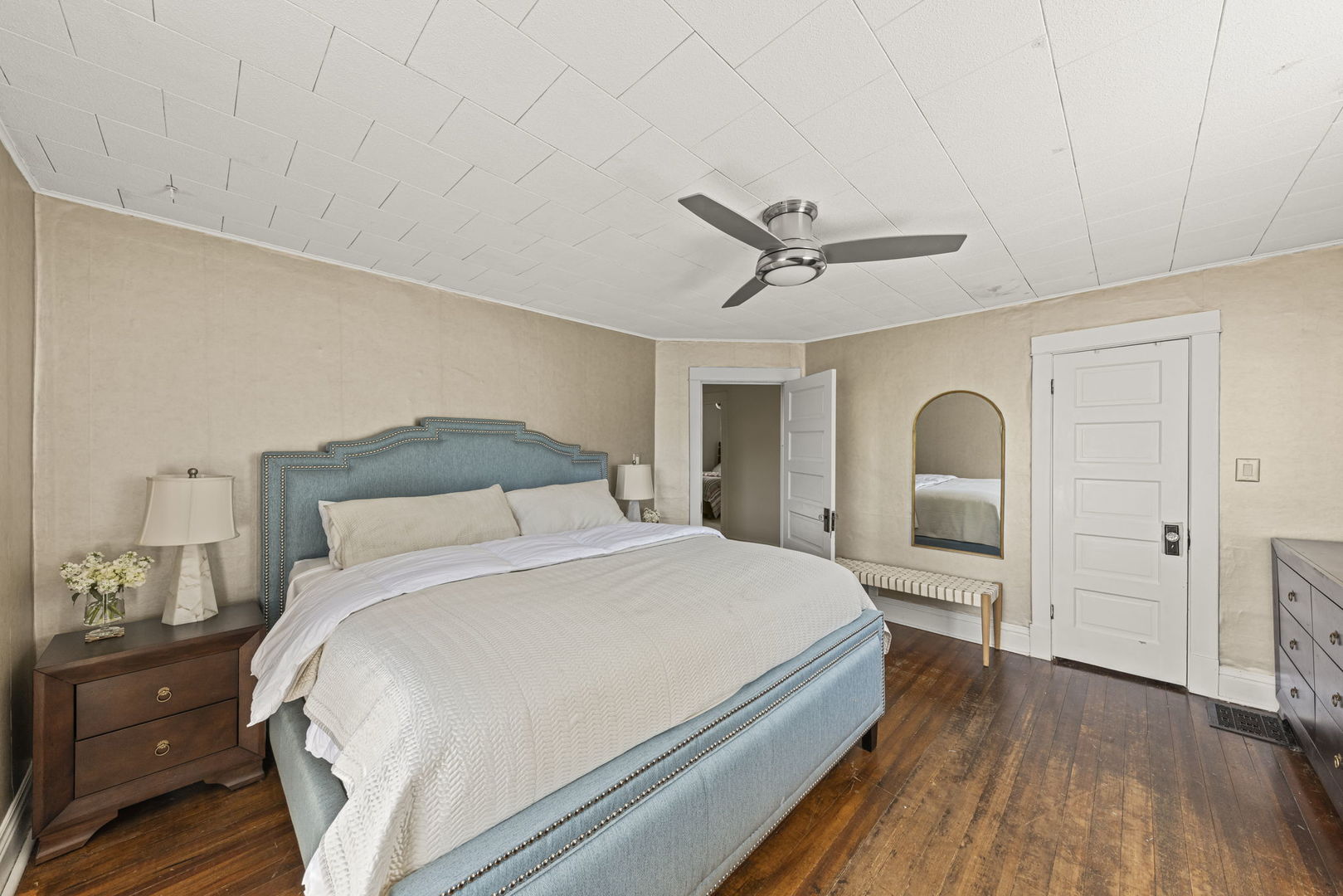 116 Columbia Street Naperville, IL 60540 - Photo 18 of 27 a bedroom with a large bed and a chandelier
