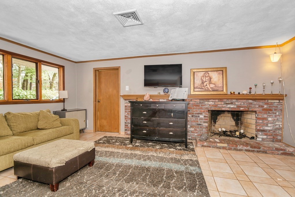 13 Ranch Road Chelmsford, MA 01824 - Photo 8 of 42 a living room with furniture and a flat screen tv