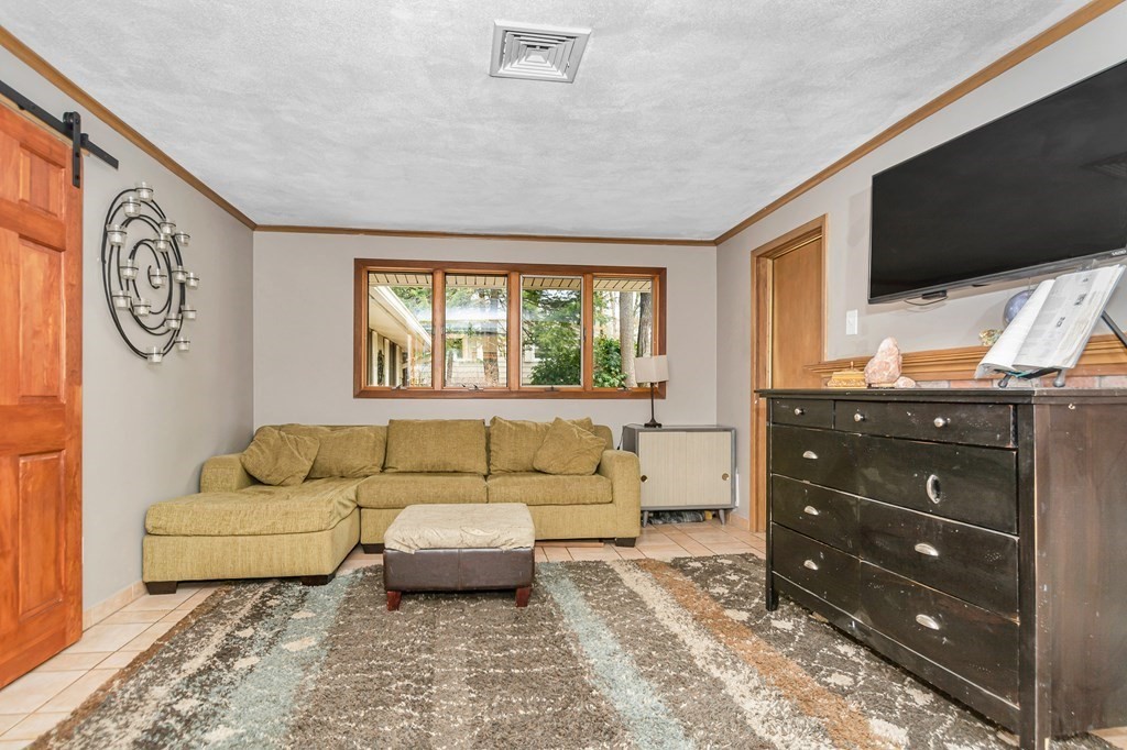 13 Ranch Road Chelmsford, MA 01824 - Photo 9 of 42 a living room with furniture and a flat screen tv