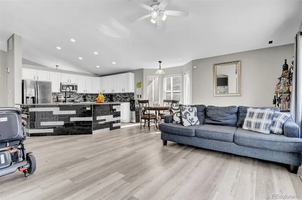 a living room with furniture and a wooden floor