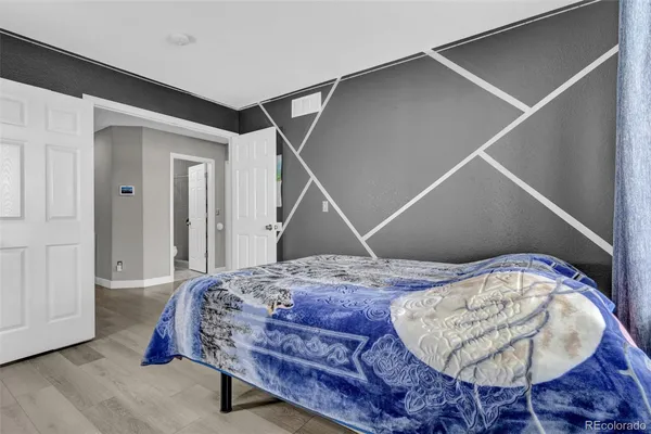 a bedroom with a bed and a chandelier