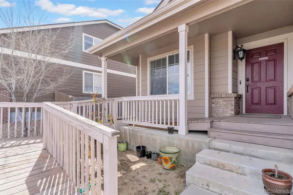 a view of a deck with couches and wooden floor