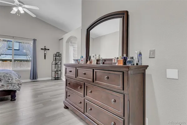 a bedroom with a large bed and a flat screen tv