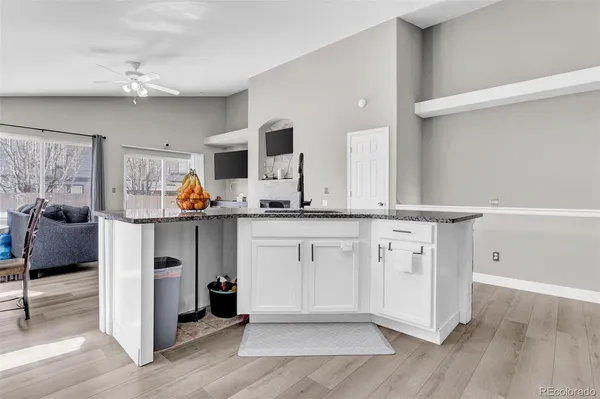 a spacious bathroom with a granite countertop sink and a mirror