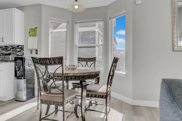 a view of a dining room with furniture and wooden floor
