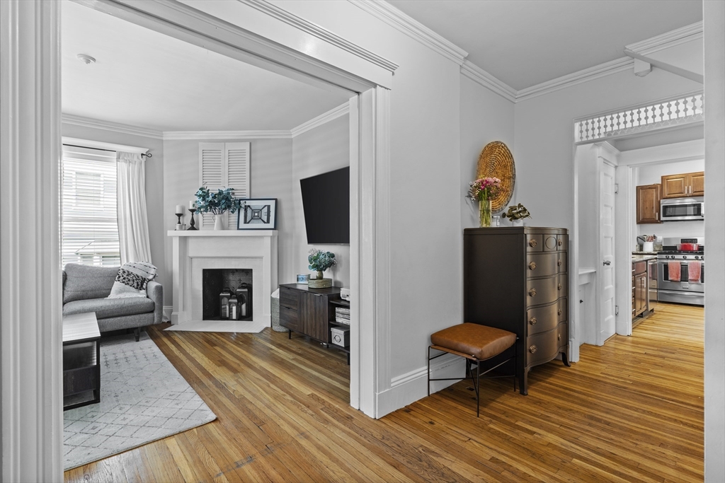 30 Chester Avenue, Unit 1 Waltham, MA 02453 - Photo 2 of 14 a living room with furniture and a fireplace