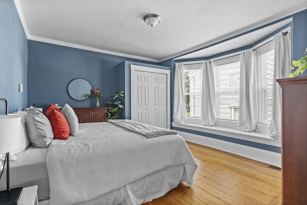 30 Chester Avenue, Unit 1 Waltham, MA 02453 - Photo 8 of 14 a bedroom with a large bed and a large window with outer view