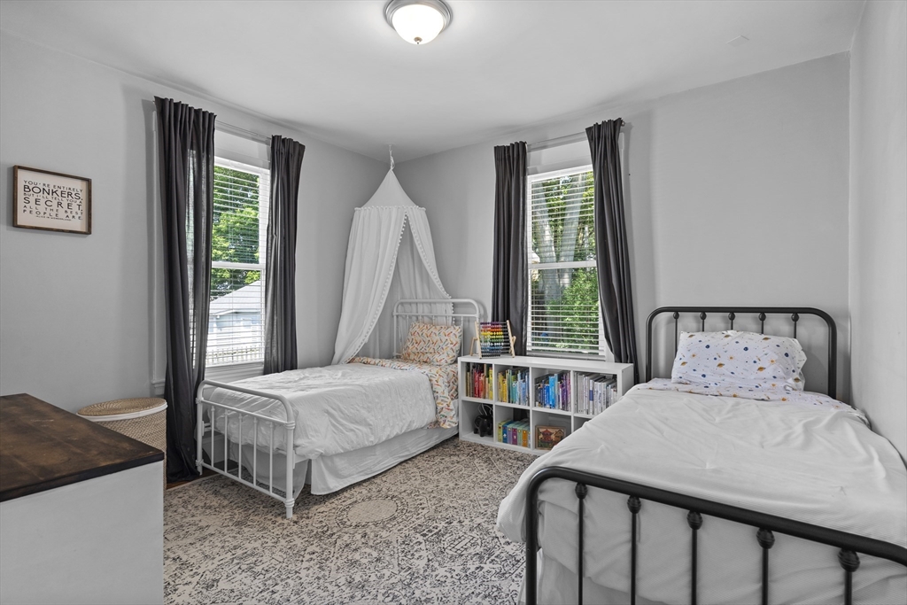 30 Chester Avenue, Unit 1 Waltham, MA 02453 - Photo 9 of 14 a bedroom with two beds and a window