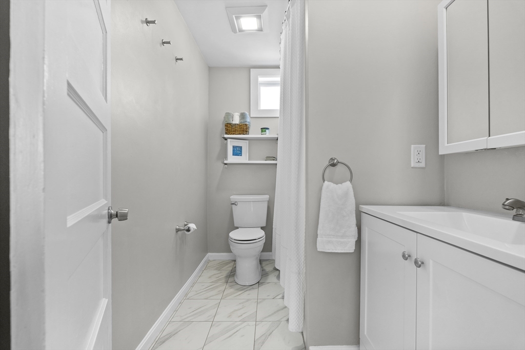 30 Chester Avenue, Unit 1 Waltham, MA 02453 - Photo 10 of 14 a bathroom with a sink toilet and shower