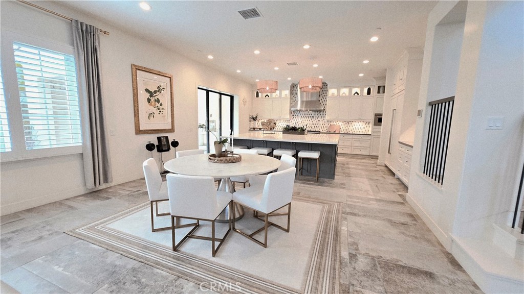 56 Redshift Irvine, CA 92618 - Photo 21 of 67 a dining room with stainless steel appliances a dining table and chairs