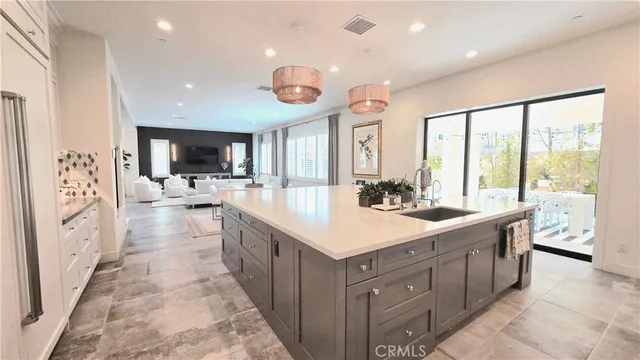 a large white bathroom with a large tub a sink a vanity and a shower
