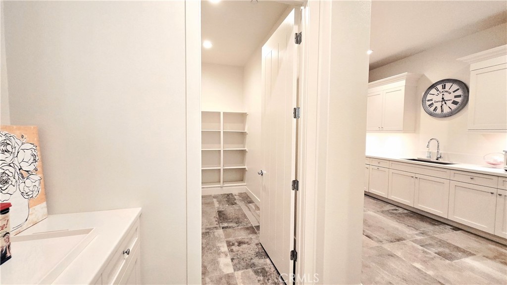 56 Redshift Irvine, CA 92618 - Photo 28 of 67 a bathroom with a granite countertop sink a vanity and a shower