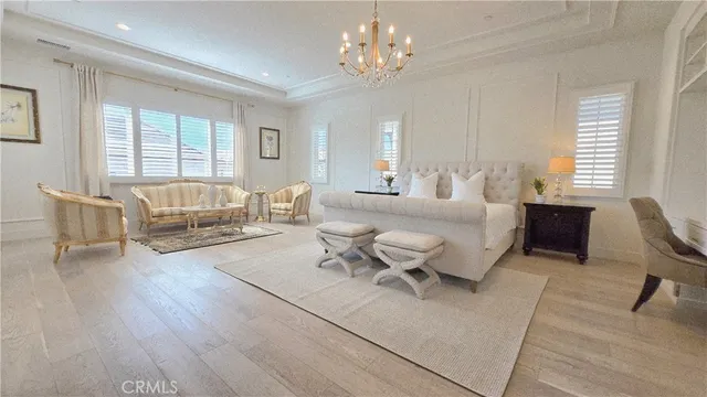 a bedroom with a bed and a flat tv screen on dresser