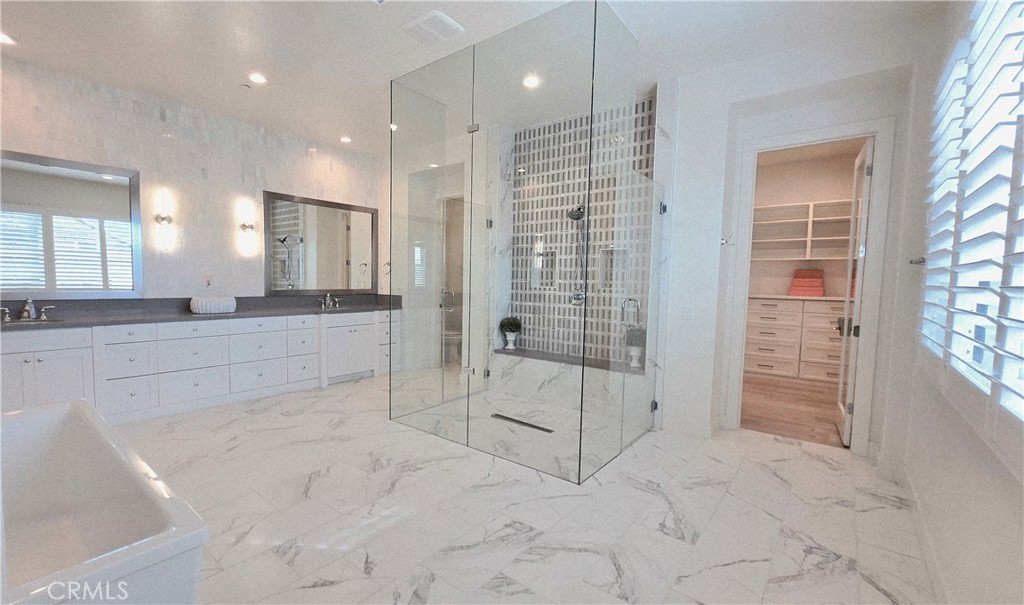 56 Redshift Irvine, CA 92618 - Photo 33 of 67 a bathroom with a glass shower door and a sink