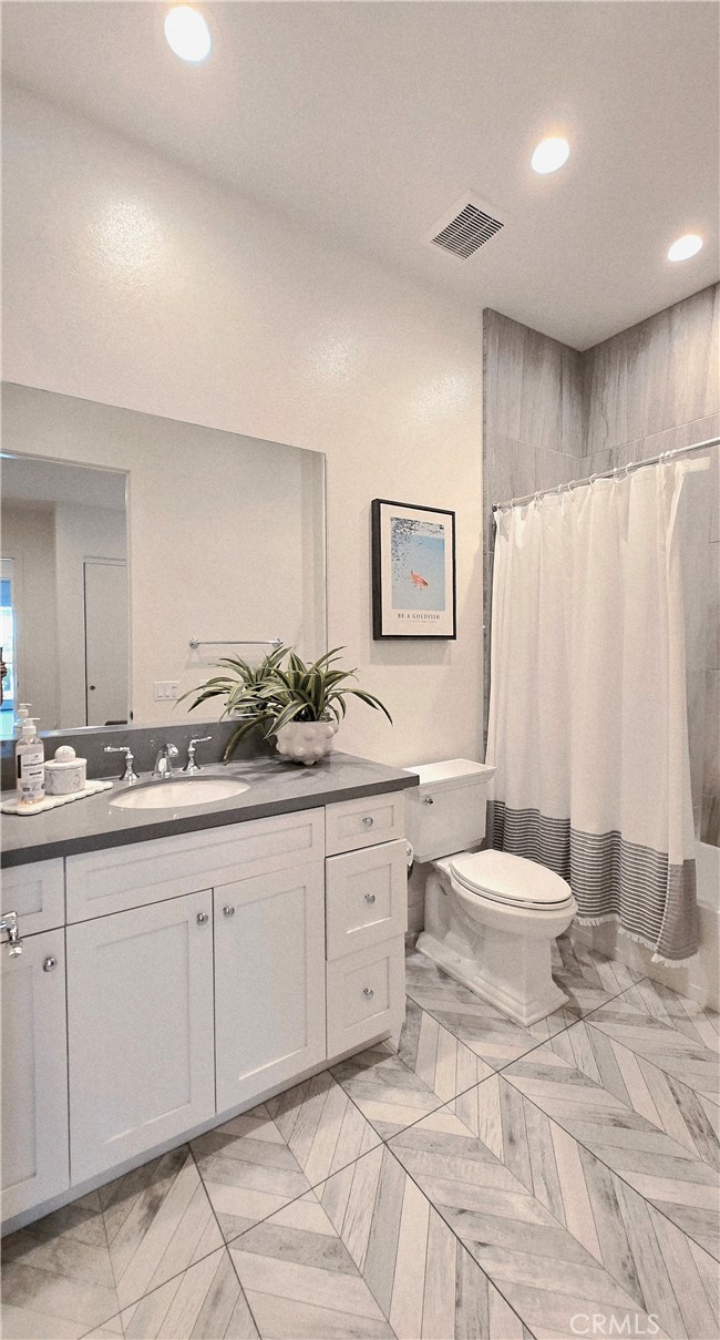 56 Redshift Irvine, CA 92618 - Photo 41 of 67 a spacious bathroom with a double vanity sink and a mirror