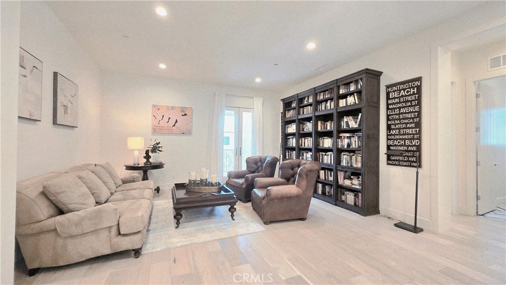 56 Redshift Irvine, CA 92618 - Photo 47 of 67 a living room with furniture and a book shelf