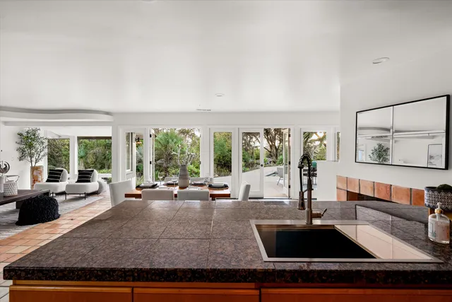 a kitchen with sink and large window