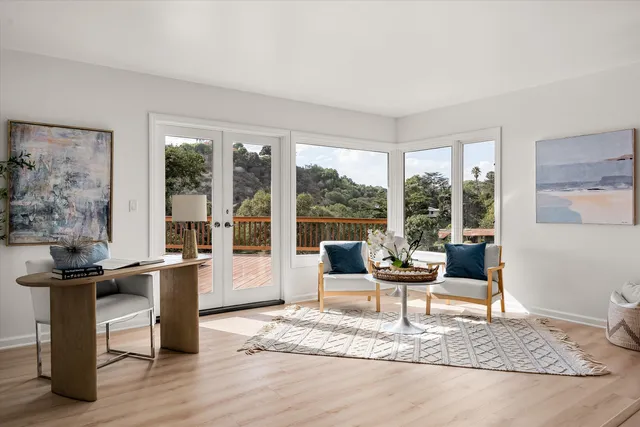 a living room with furniture and large window