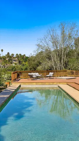a view of swimming pool with outdoor seating and yard in the back