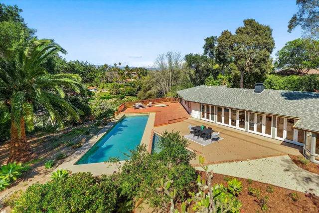 an aerial view of a house with a yard