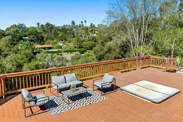 a view of a chair and tables on the roof deck