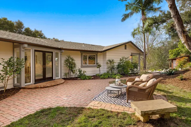 a view of a patio with table and chairs and potted plants