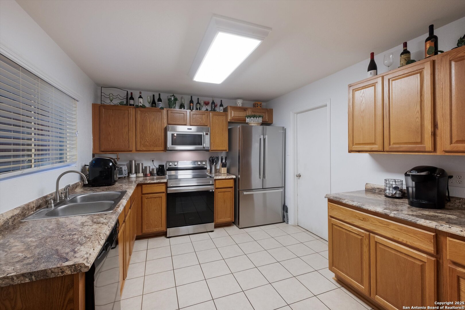 10711 Rindle Ranch San Antonio, TX 78249 - Photo 11 of 31 a kitchen with stainless steel appliances granite countertop a sink stove and refrigerator