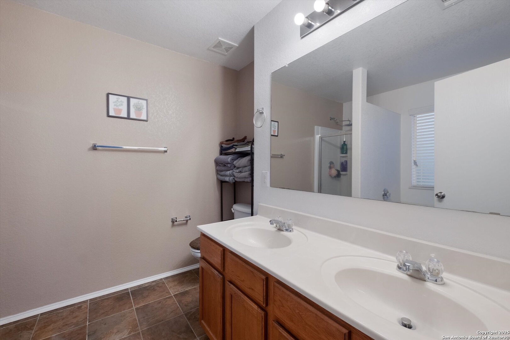 10711 Rindle Ranch San Antonio, TX 78249 - Photo 18 of 31 a bathroom with a sink and a mirror