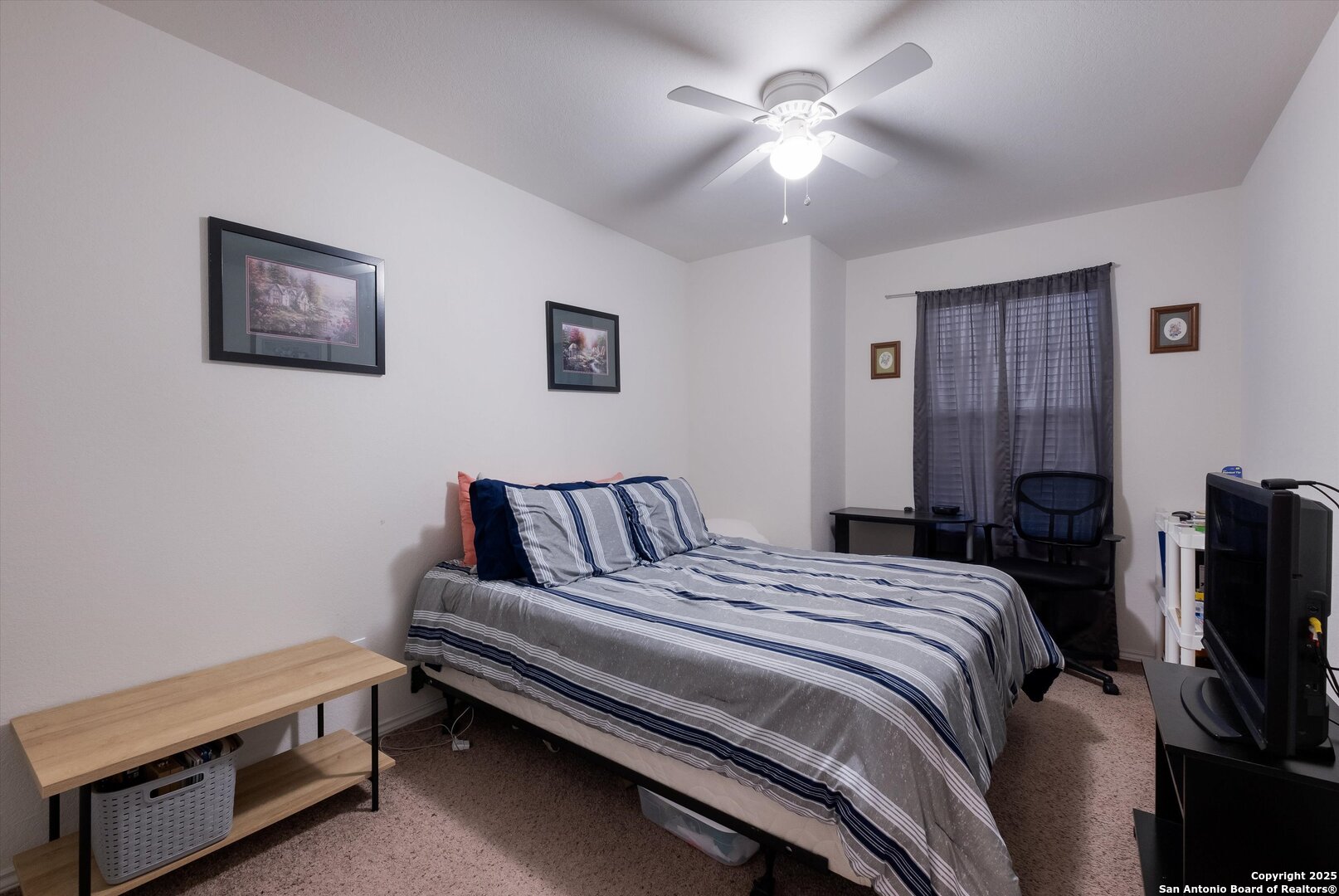 10711 Rindle Ranch San Antonio, TX 78249 - Photo 21 of 31 a bedroom with a bed and a chandelier