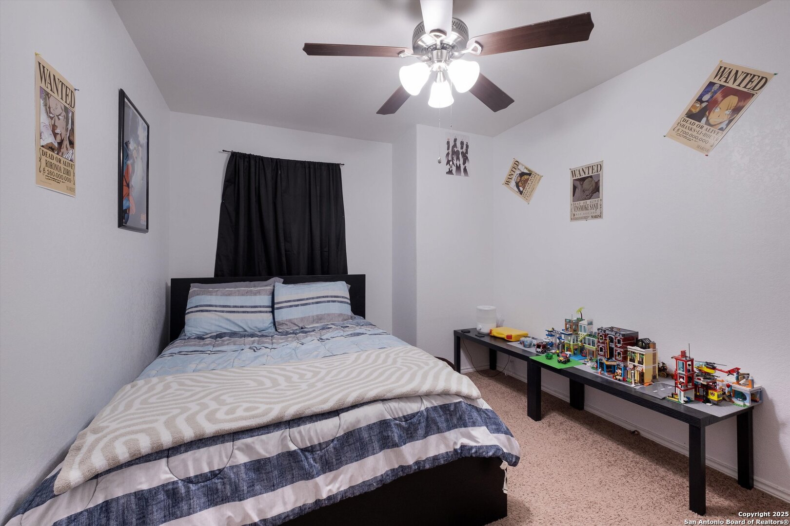 10711 Rindle Ranch San Antonio, TX 78249 - Photo 22 of 31 a bedroom with bed and a chandelier