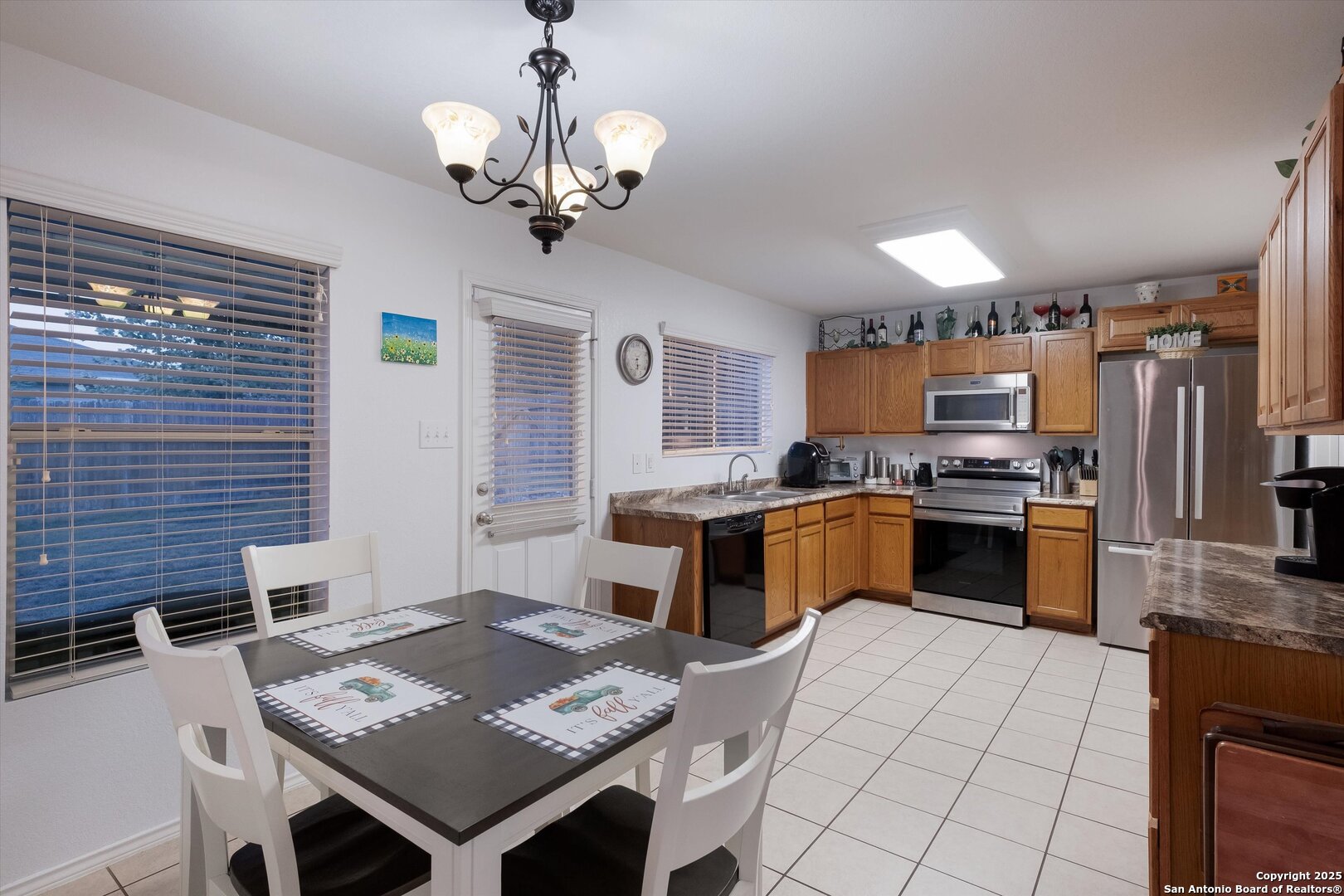 10711 Rindle Ranch San Antonio, TX 78249 - Photo 8 of 31 a kitchen with a chandelier appliances and cabinets