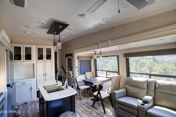 a kitchen with a appliances cabinets and furniture