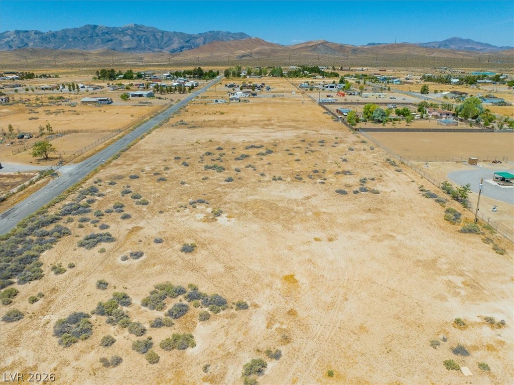 4580 Lawrence Road Pahrump, NV 89048 - Photo 22 of 40 A vast, undeveloped parcel of land with scattered desert flora, offering broad views of distant mountains.