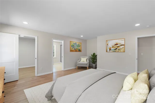 a bedroom with a bed and wooden floor