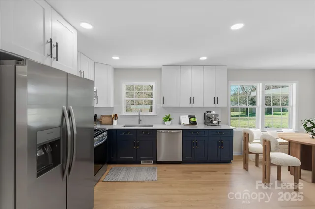 a kitchen with stainless steel appliances granite countertop a refrigerator sink and cabinets