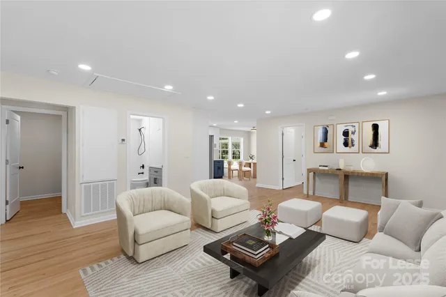 a living room with furniture and wooden floor