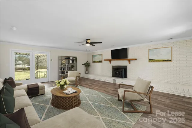 a living room with furniture a fireplace and a flat screen tv