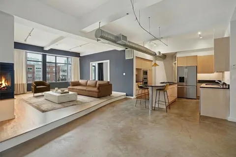 a kitchen with stainless steel appliances kitchen island granite countertop a refrigerator and a stove top oven