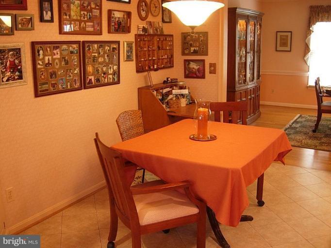 15212 Redgate Drive Silver Spring, MD 20905 - Photo 12 of 28 a dining room with furniture and wooden floor