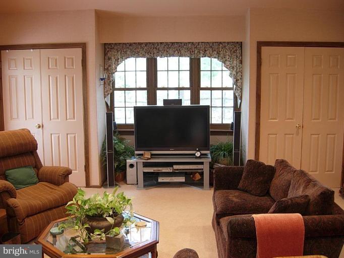 15212 Redgate Drive Silver Spring, MD 20905 - Photo 15 of 28 a living room with furniture and a flat screen tv