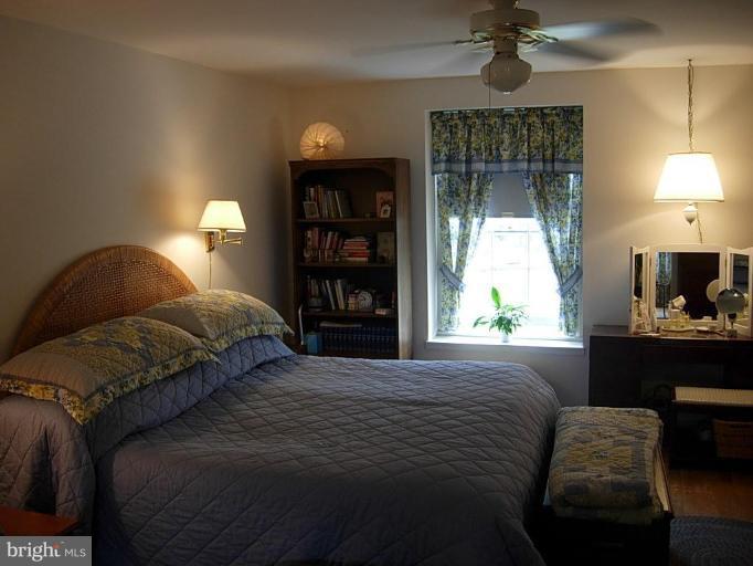 15212 Redgate Drive Silver Spring, MD 20905 - Photo 18 of 28 a bedroom with a bed lamps and window