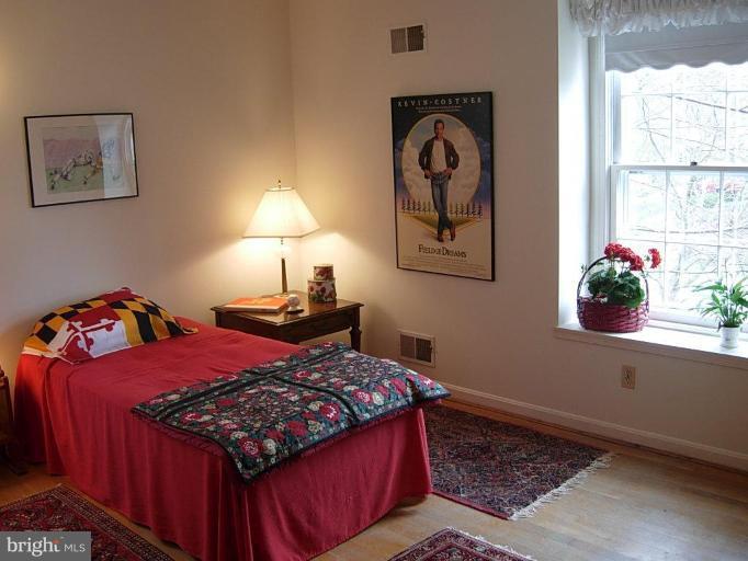 15212 Redgate Drive Silver Spring, MD 20905 - Photo 21 of 28 a bed sitting in a bedroom next to a window
