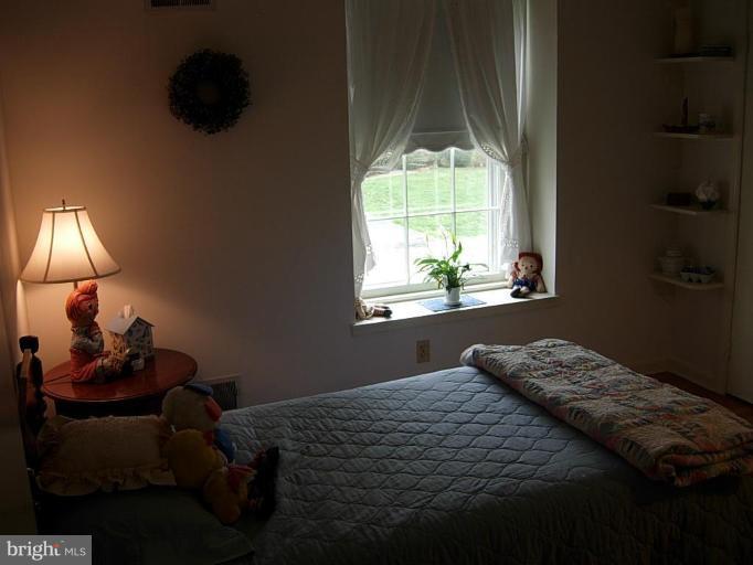15212 Redgate Drive Silver Spring, MD 20905 - Photo 22 of 28 a bedroom with a bed and a window