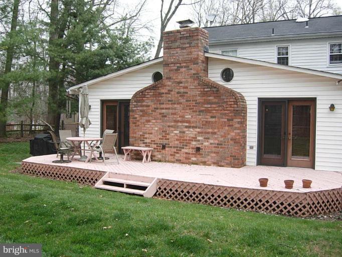 15212 Redgate Drive Silver Spring, MD 20905 - Photo 24 of 28 a front view of a house with a garden